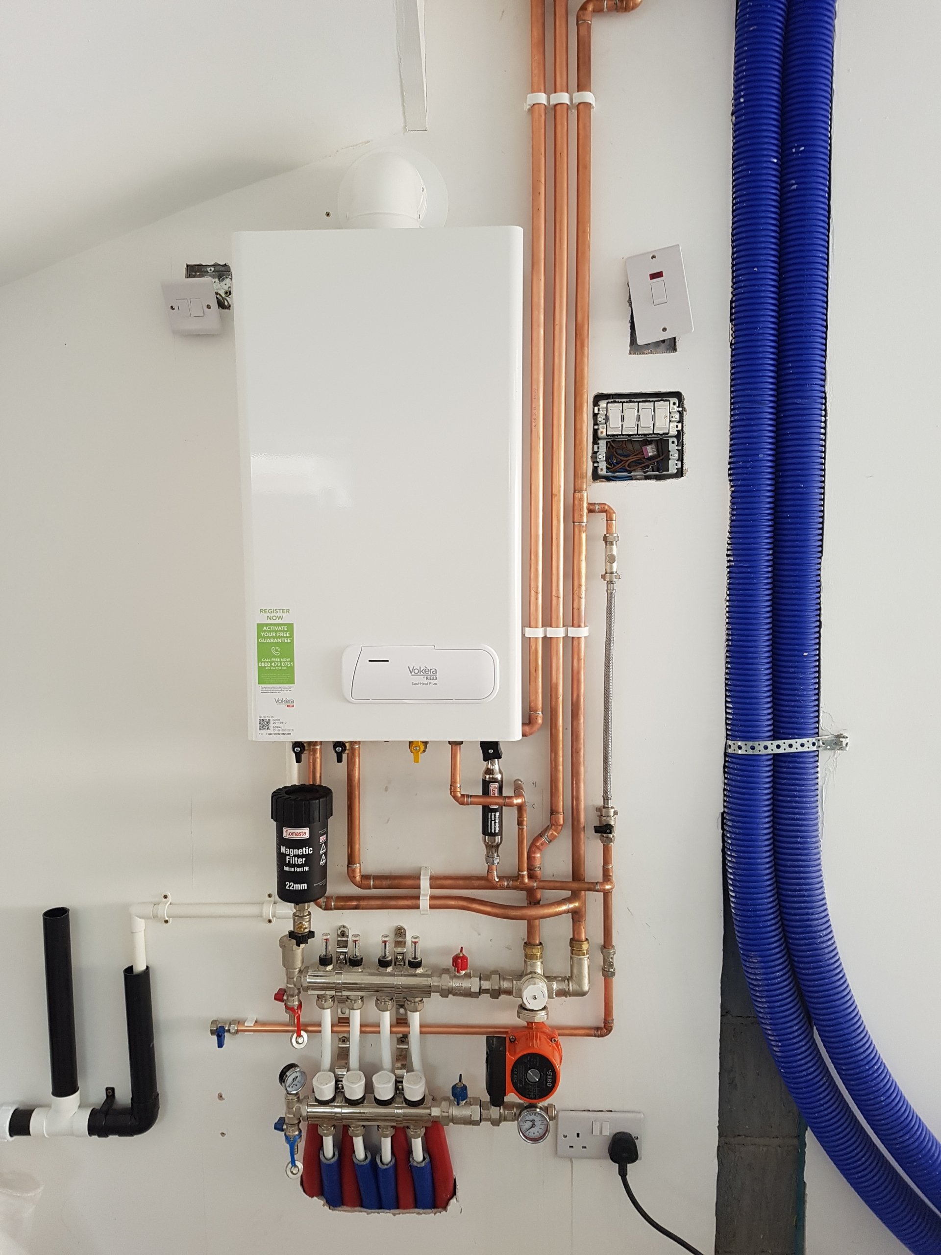 domestic-gas-combi-boiler-and-pipework-installed-in-an-english-home-uk